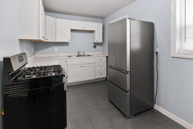 3804 NE 26th Ave, Amarillo, TX 79107 - kitchen with stainless steel appliances, a sink, light countertops, and white cabinetry