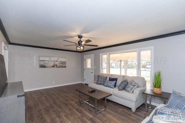 living area with crown molding, baseboards, a ceiling fan, and dark wood finished floors