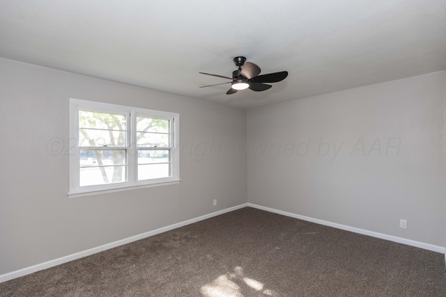 empty room featuring a ceiling fan, baseboards, and dark colored carpet