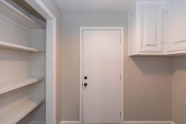 interior space featuring baseboards