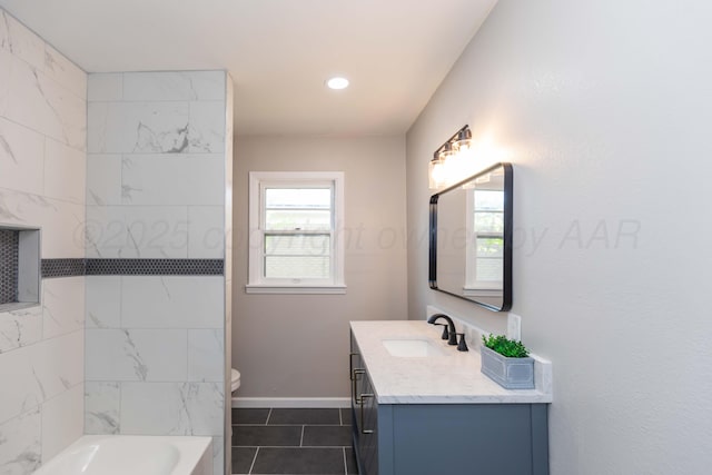 bathroom with tile patterned flooring, vanity, recessed lighting, baseboards, and a tub to relax in