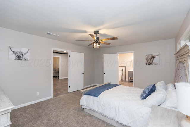 bedroom with visible vents, baseboards, ceiling fan, light colored carpet, and connected bathroom