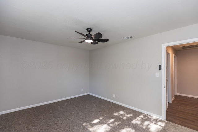 carpeted spare room featuring baseboards, ceiling fan, and visible vents