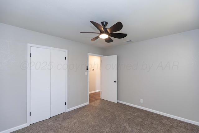 unfurnished bedroom with baseboards, visible vents, ceiling fan, and carpet