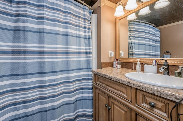 bathroom with vanity and ornamental molding