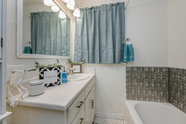 bathroom featuring a tub to relax in, vanity, and tile patterned flooring