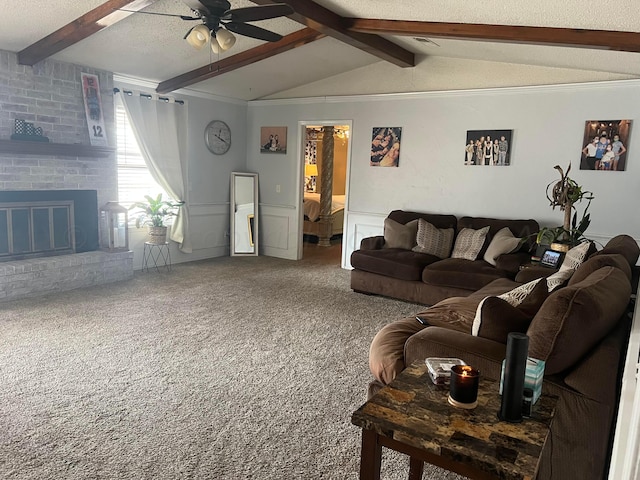 living room with carpet floors, a textured ceiling, ceiling fan, a fireplace, and lofted ceiling with beams