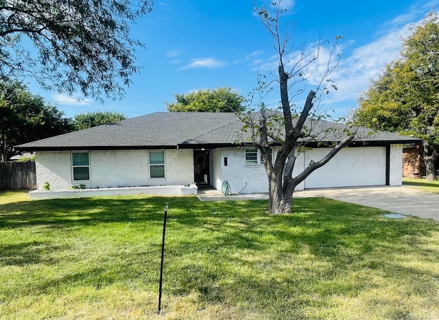 ranch-style home featuring a garage and a front yard