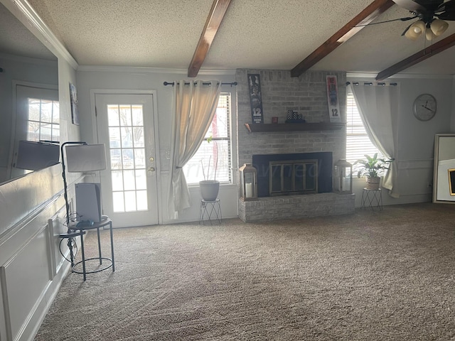 unfurnished living room featuring beamed ceiling, a textured ceiling, and carpet floors