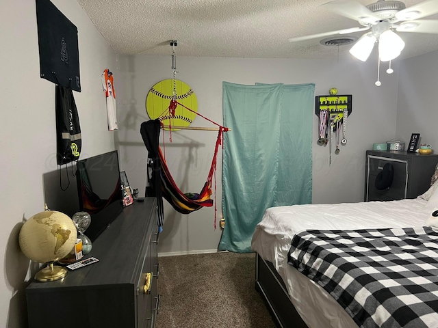 carpeted bedroom with a textured ceiling and ceiling fan