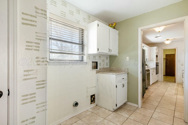 227 Inverness St, Borger, TX 79007 - laundry area featuring hookup for a washing machine, cabinet space, and light tile patterned flooring