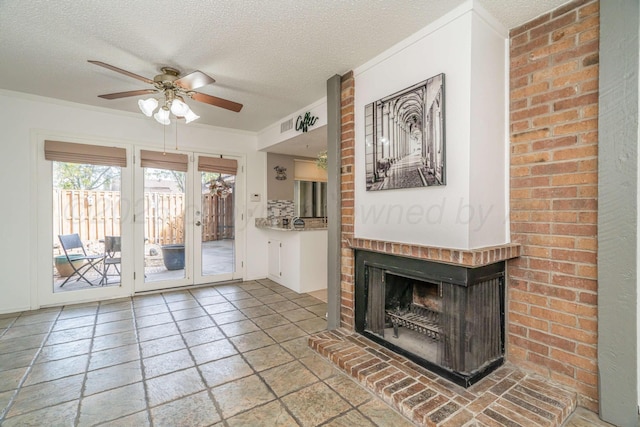3000 Fleetwood Dr, Amarillo, TX 79109 - unfurnished living room featuring a textured ceiling, a ceiling fan, a fireplace, stone tile flooring, and ornamental molding