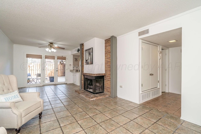 3000 Fleetwood Dr, Amarillo, TX 79109 - unfurnished living room with a textured ceiling, a ceiling fan, a brick fireplace, and french doors