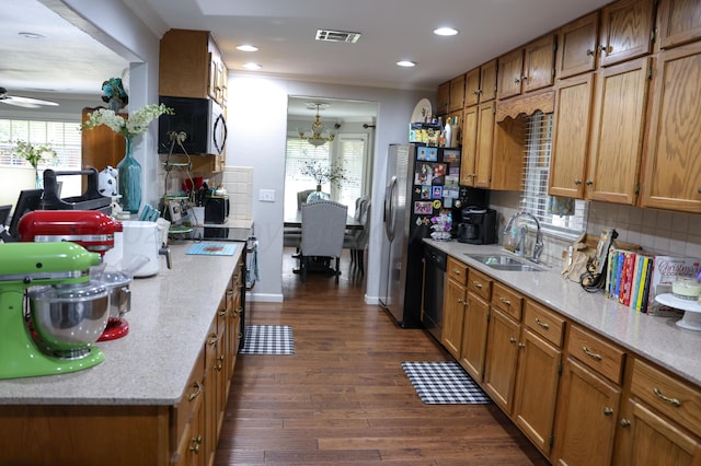 210 Ranger St, Hereford, TX 79045 - kitchen with appliances with stainless steel finishes, brown cabinetry, healthy amount of natural light, and recessed lighting