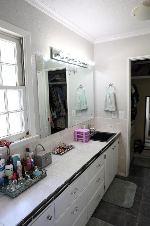 210 Ranger St, Hereford, TX 79045 - bathroom featuring a spacious closet, crown molding, tile patterned floors, vanity, and healthy amount of natural light
