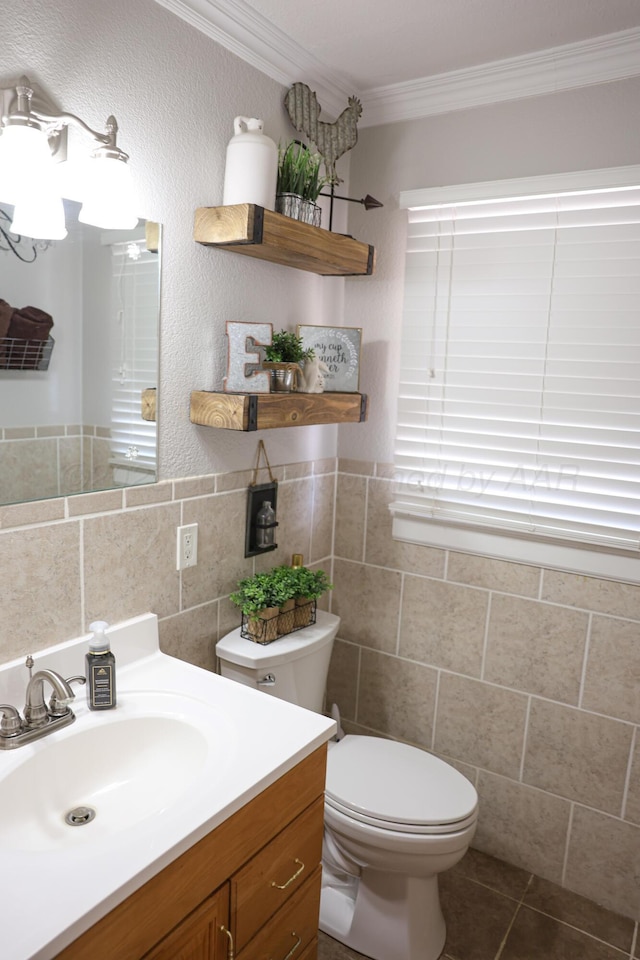 210 Ranger St, Hereford, TX 79045 - half bathroom with crown molding, vanity, tile walls, and tile patterned floors