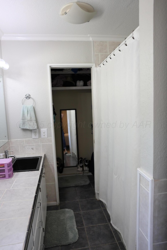 210 Ranger St, Hereford, TX 79045 - bathroom with vanity, tile patterned floors, crown molding, and a shower with shower curtain
