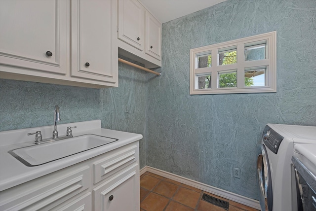3408 Carlton Dr, Amarillo, TX 79109 - laundry room featuring cabinet space, independent washer and dryer, baseboards, and dark tile patterned flooring