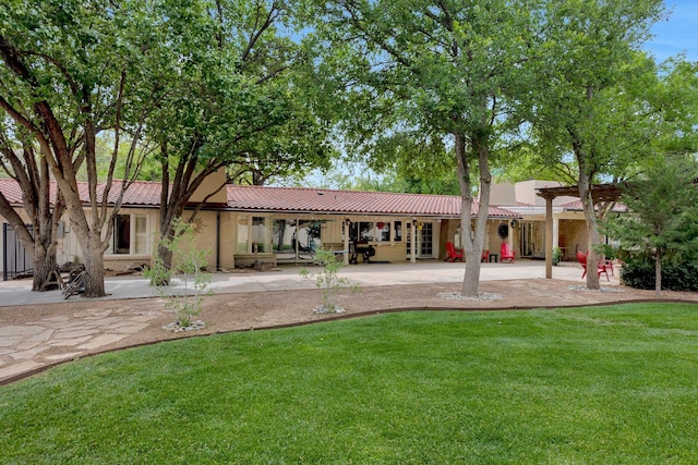 3408 Carlton Dr, Amarillo, TX 79109 - rear view of property with stucco siding, a yard, a tiled roof, and a patio area