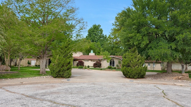 3408 Carlton Dr, Amarillo, TX 79109 - obstructed view of property featuring a chimney, a tiled roof, and stucco siding