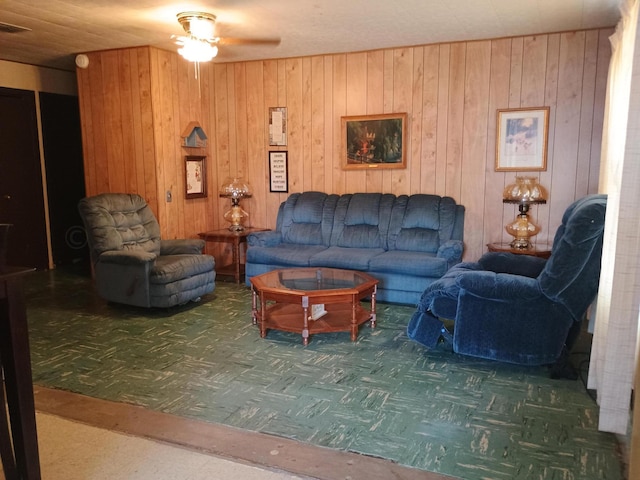 living room with wood walls and ceiling fan