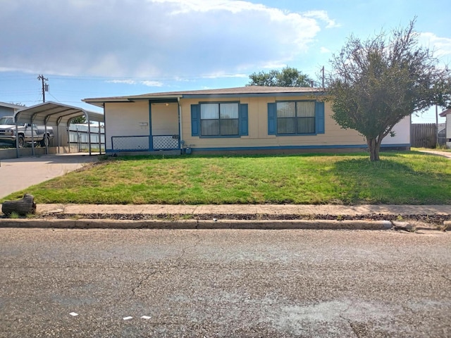 view of front facade with a front yard and a carport