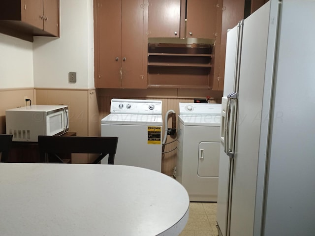 kitchen with washer and dryer and white fridge with ice dispenser