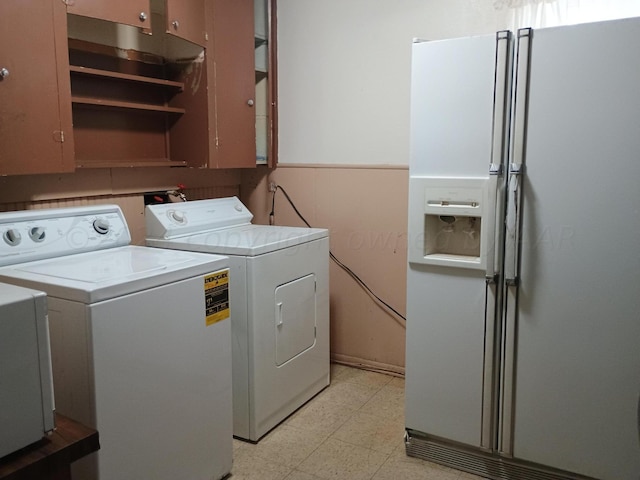 905 Harrington St, Borger, TX 79007 - clothes washing area with washer and dryer, cabinet space, and light floors