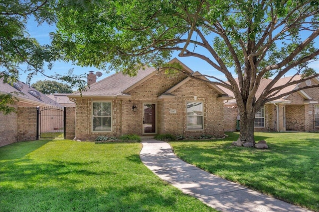 3507 Brennan Gdns, Amarillo, TX 79121 - view of front of house with a gate, brick siding, a chimney, and a front lawn