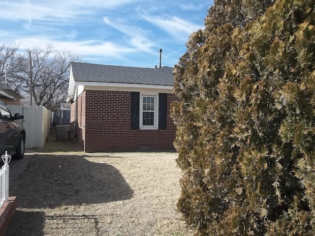 view of side of home featuring central AC