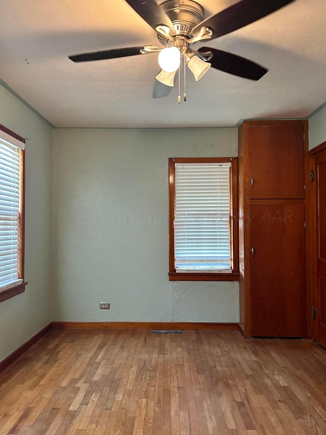 spare room featuring light hardwood / wood-style floors and ceiling fan