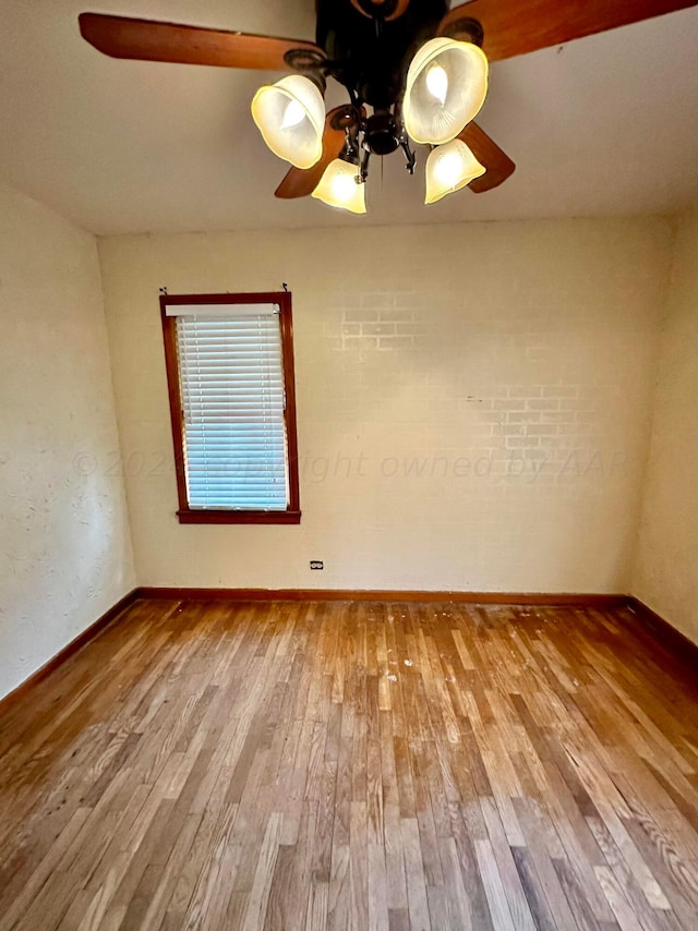 spare room featuring wood-type flooring