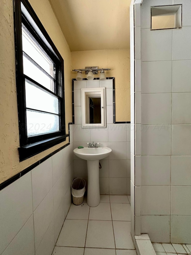 bathroom with tile patterned flooring and tile walls