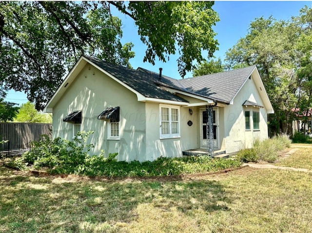 bungalow-style home with a front yard