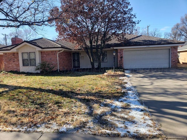 single story home featuring a garage and a front lawn