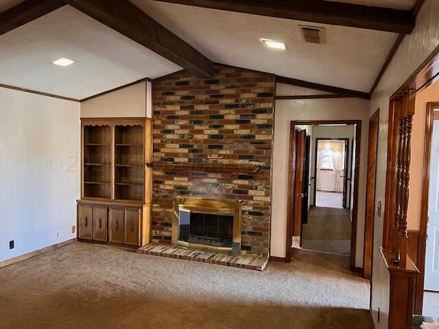 unfurnished living room featuring a fireplace, carpet floors, and vaulted ceiling with beams