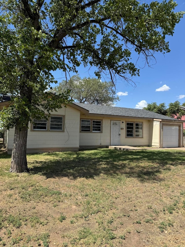 ranch-style home featuring a garage and a front yard