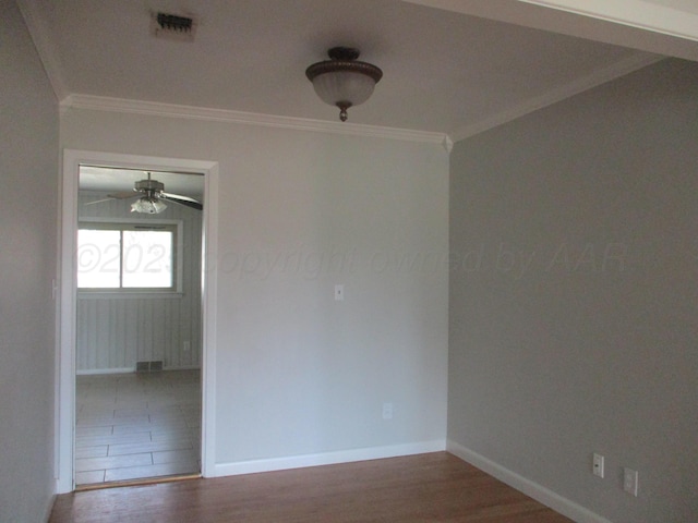 unfurnished room with wood finished floors, baseboards, ornamental molding, and a ceiling fan