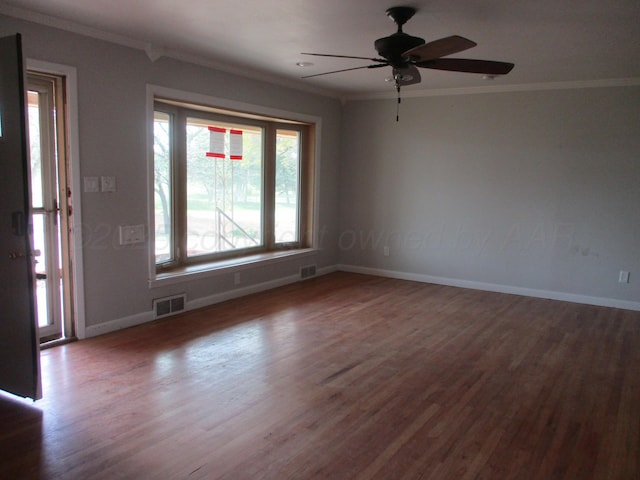 unfurnished room with baseboards, ornamental molding, wood finished floors, and a ceiling fan