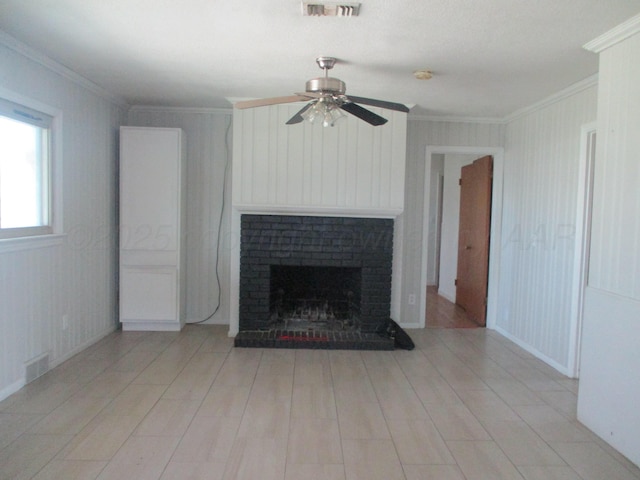 unfurnished living room with ornamental molding, a ceiling fan, a fireplace, and light wood-style floors