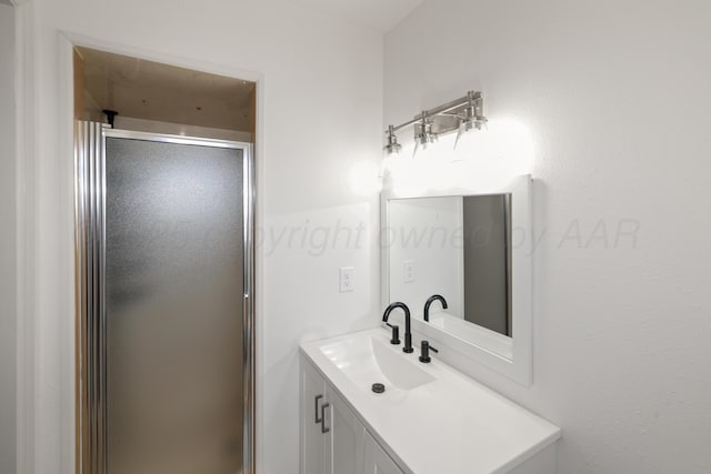 bathroom featuring vanity and a shower with door