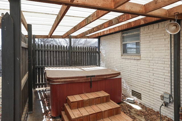 wooden terrace featuring a hot tub