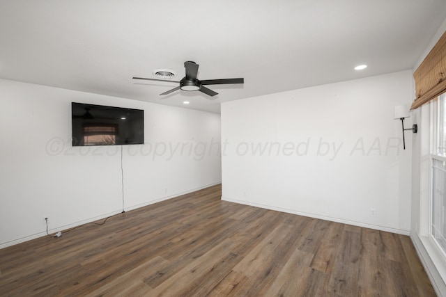 spare room featuring ceiling fan and dark hardwood / wood-style flooring