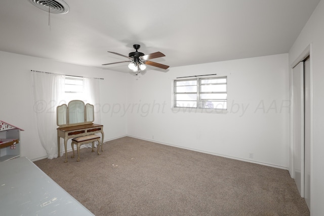 unfurnished bedroom featuring carpet floors and ceiling fan