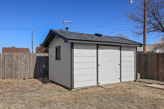 view of outbuilding with a lawn