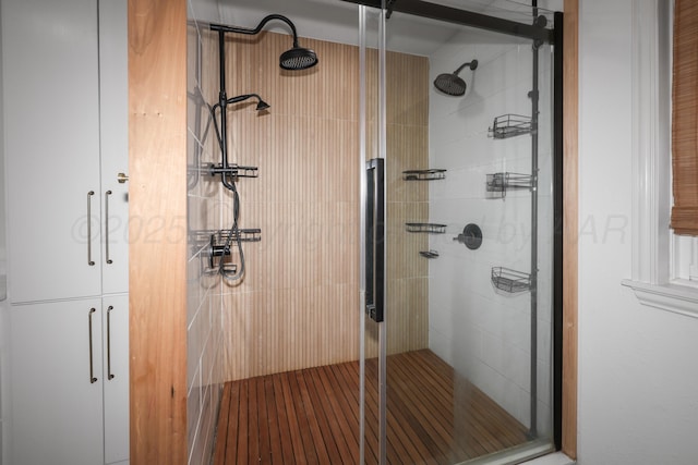 bathroom with a shower with shower door