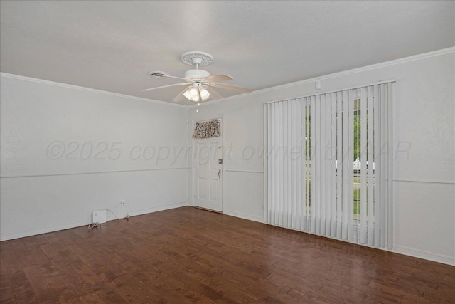 empty room with ceiling fan, crown molding, baseboards, and wood finished floors