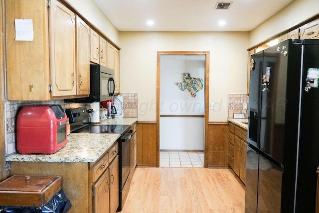 8403 Whittier Dr, Amarillo, TX 79110 - kitchen with black appliances, light countertops, light wood finished floors, a wainscoted wall, and recessed lighting