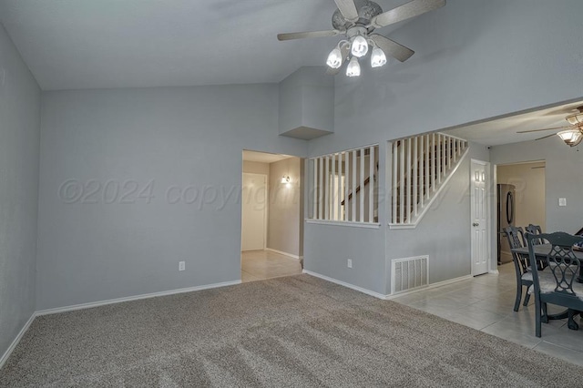 carpeted spare room with ceiling fan and lofted ceiling