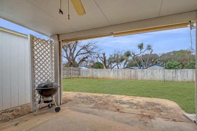 view of patio with ceiling fan and a grill